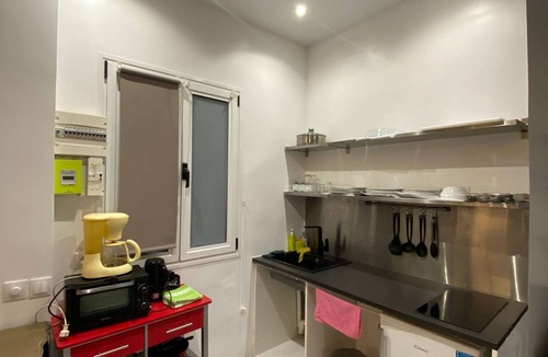 Quartier Saint-Georges Apartment | The apartment has a bed, a sofa bed and a kitchen with a refrigerator.