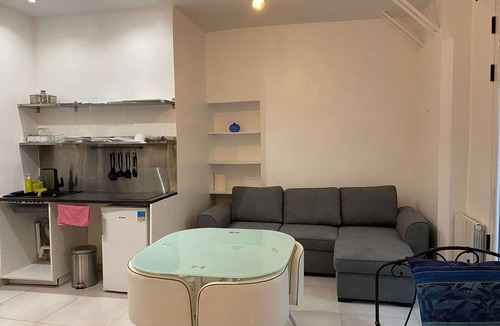 Quartier Saint-Georges Apartment | The apartment has a bed, a sofa bed and a kitchen with a refrigerator.