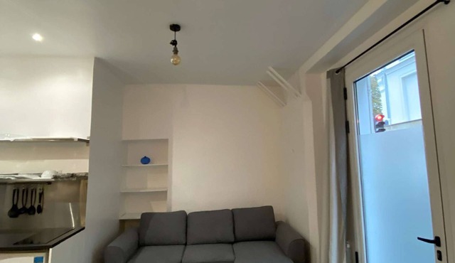 The apartment has a bed, a sofa bed and a kitchen with a refrigerator.